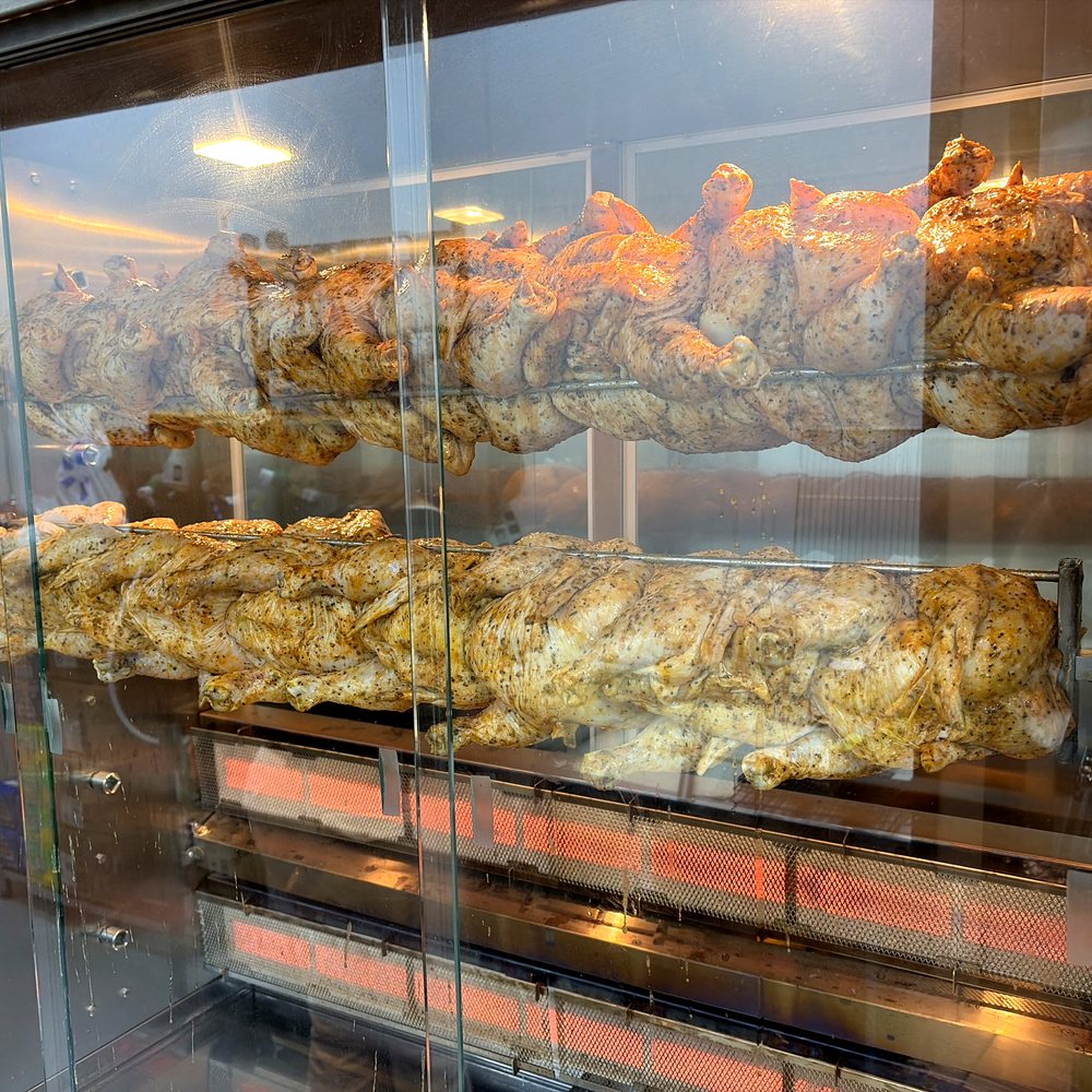 Whole chickens turning on the vertical rotisserie