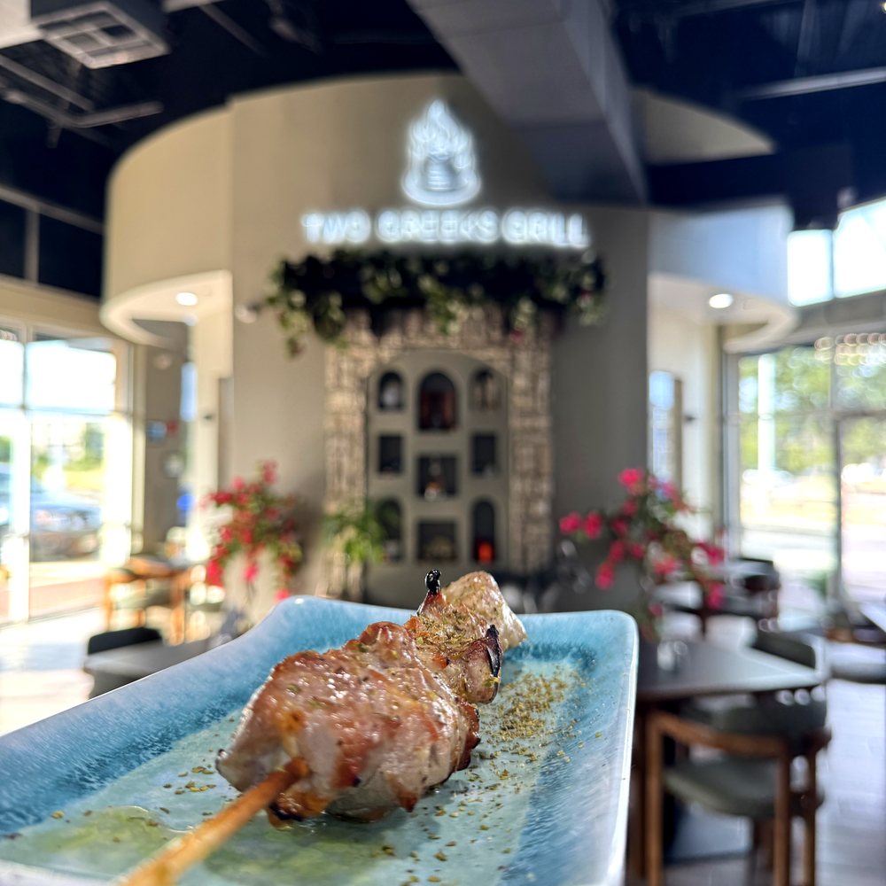Flame-grilled pork souvlaki skewer